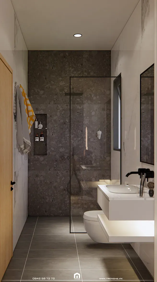 Không gian nhà vệ sinh N’ House được ốp gạch toàn bộ cho sàn và tường