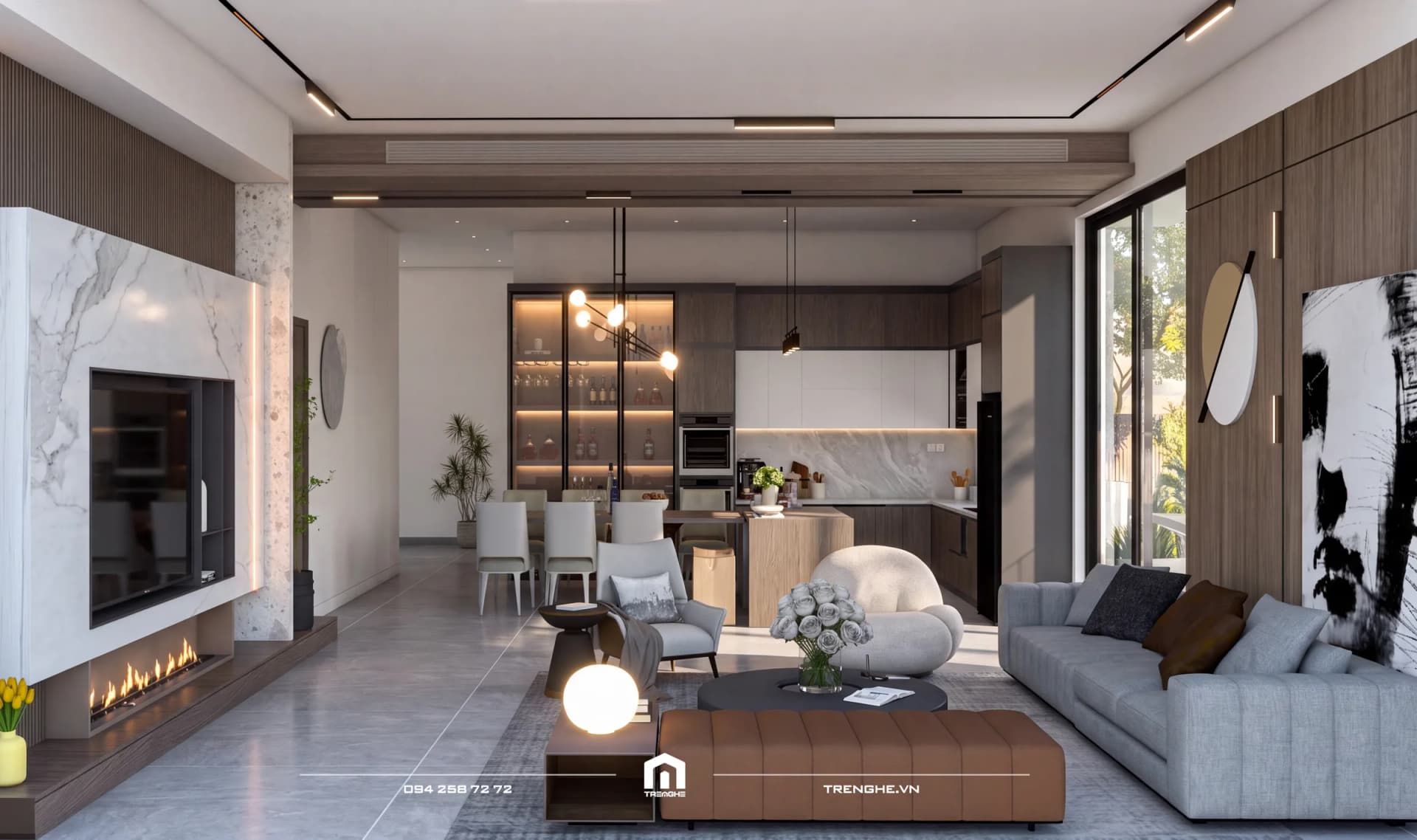 Phòng khách D’ House liên thông bàn ăn và bếp chữ L, vách tivi đá trắng có lò sưởi, sofa xám và tủ rượu kính sáng đèn