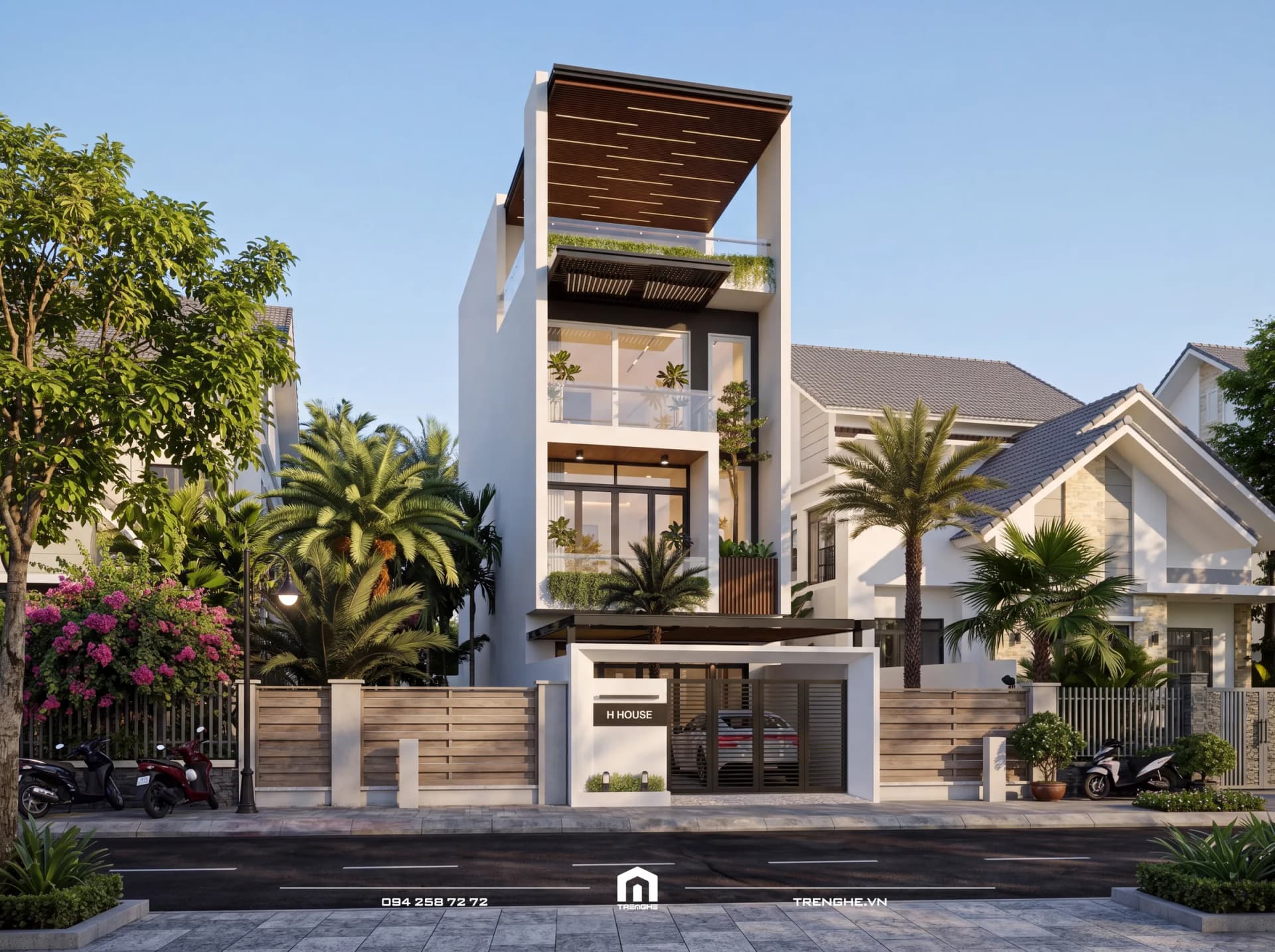 Mặt tiền H’ House 615 ban ngày: khung trắng lớn, mặt kính lùi sâu với ban công cây xanh, mái phẳng ốp gỗ trên cùng và hàng rào nan gỗ nằm ngang