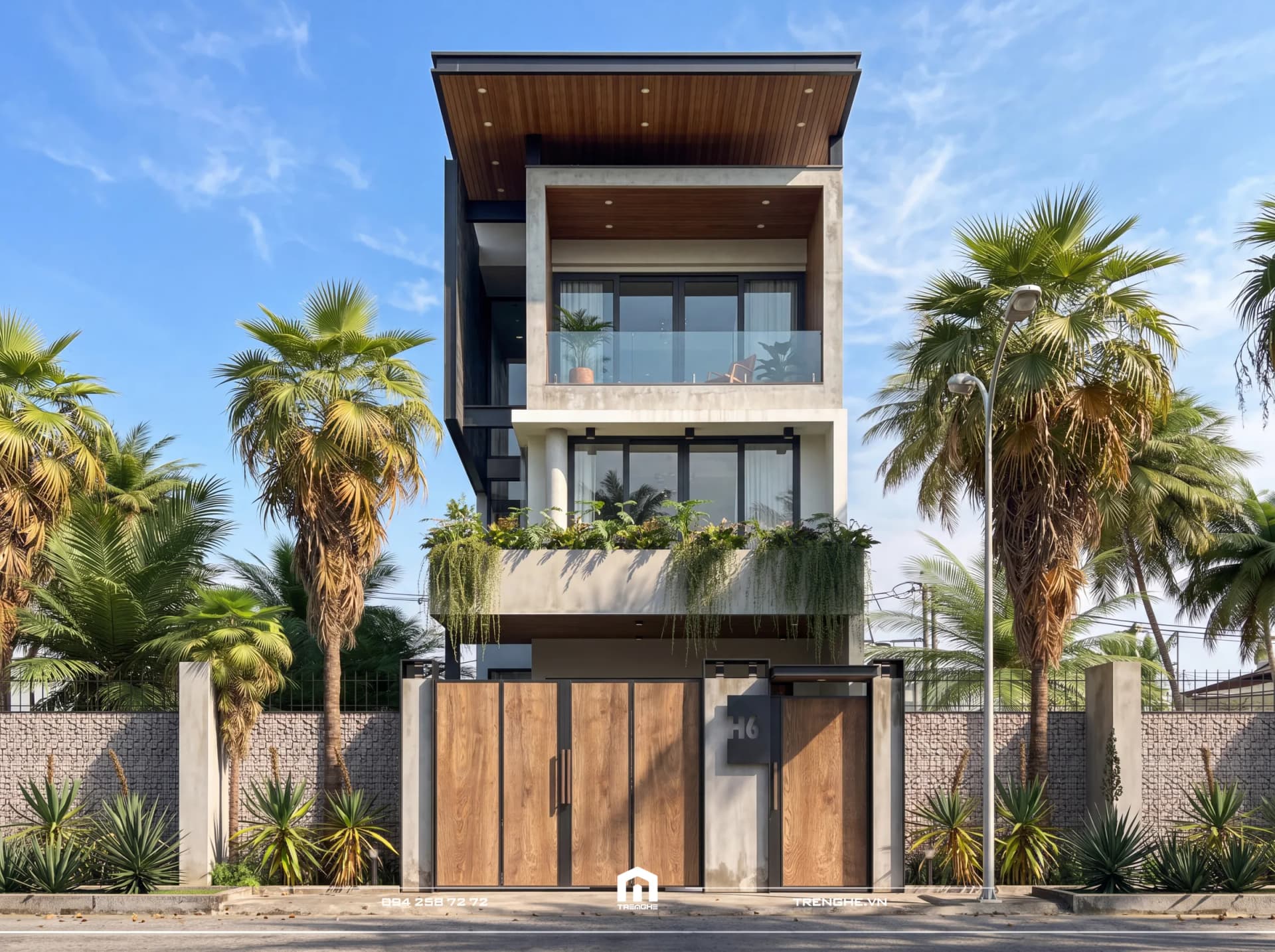 Mặt tiền nhà phố 3 tầng T’ House Hòa Long ban ngày với mái bằng ốp lam gỗ, ban công kính và bồn cây rủ