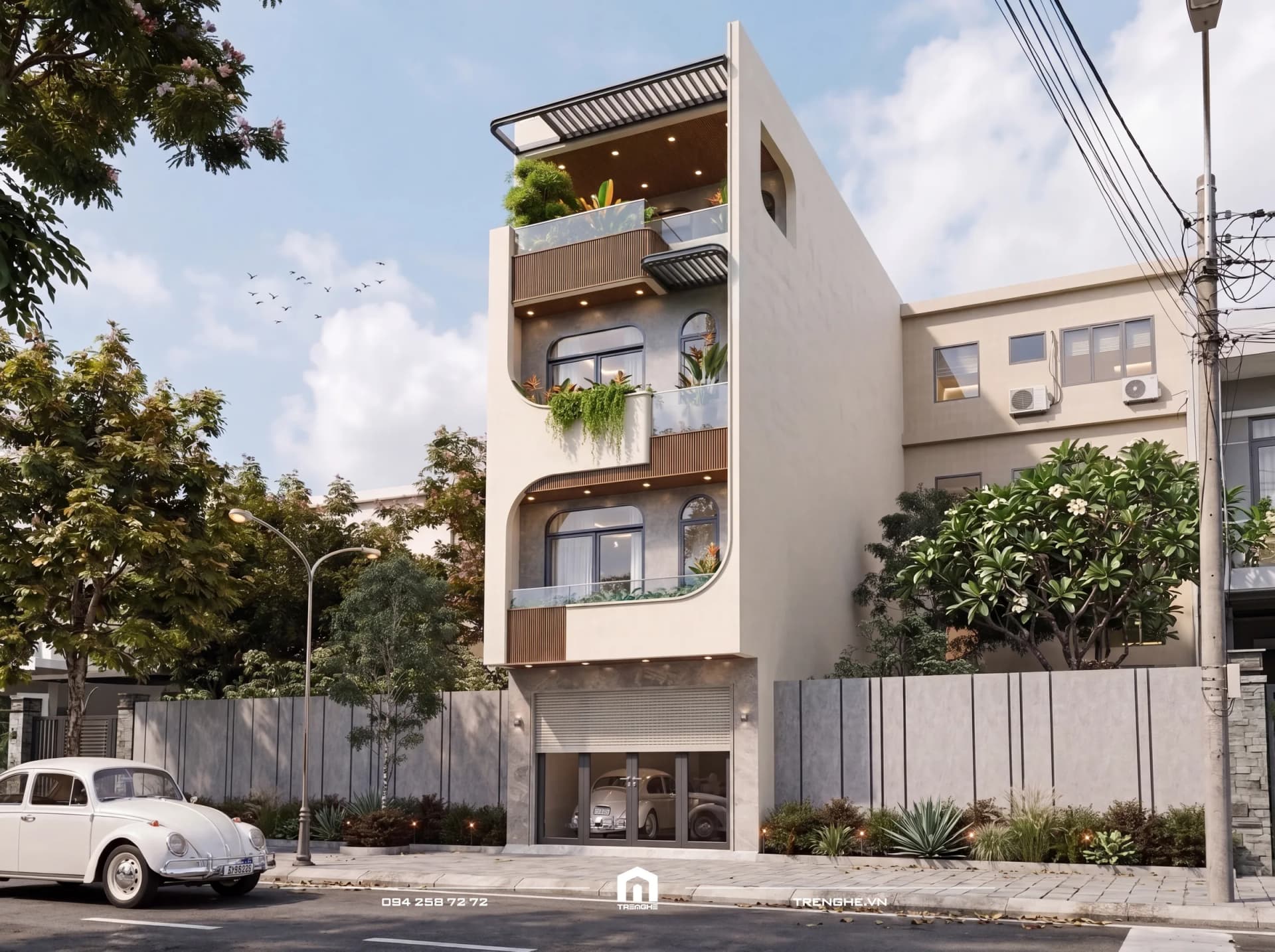 Mặt tiền nhà phố V’ House 1 trệt 3 lầu ban ngày: ban công bo cong xếp tầng, cửa sổ vòm, bồn cây rủ xanh, giàn lam sân thượng và xe cổ màu trắng trước nhà